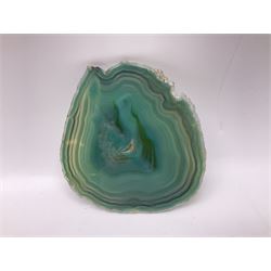 Pair of green agate slices, polished with rough edges, raised upon silvered metal stands, H23cm