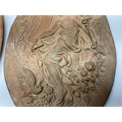 Pair of 19th century classical terracotta relief wall plaques depicting the goddess Hygeia and another goddess, seated holding an ewer, each of oval form, indistinctly signed, each stamped Ferreira verso, H42cm, W30cm
