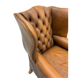 Georgian design wingback armchair, upholstered in buttoned tan leather