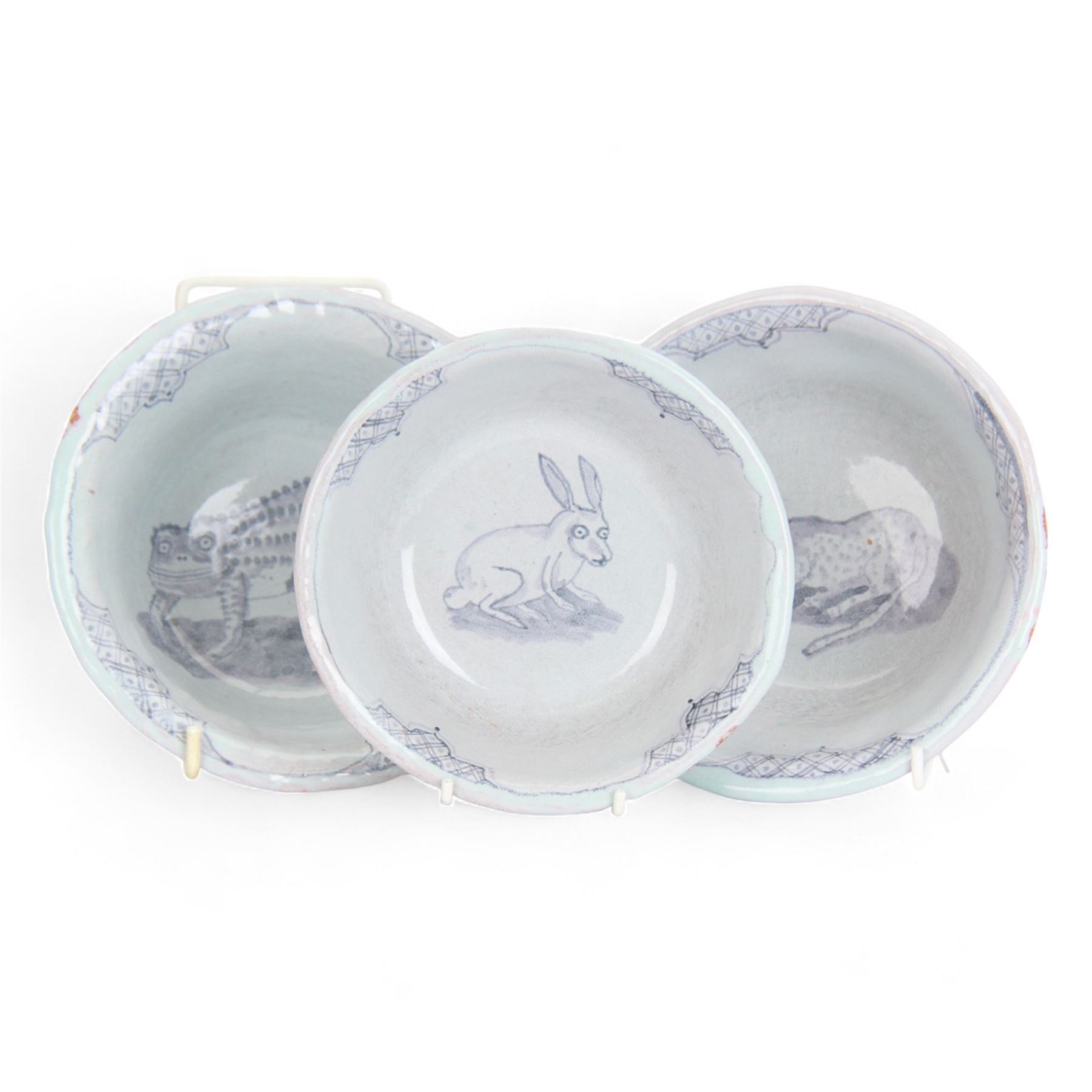 Hylton Nel (1941-); Three bowls, 1994, the blue ground each decorated internally with an animal, hare, leopard and lizard,  with makers mark and date to the base HN. 4.11.94, D15cm
