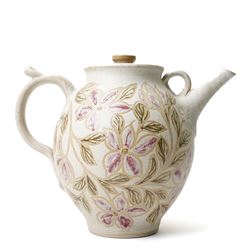 John Egerton (c1945-2024): studio pottery teapot, decorated with foliage and flowers on a cream ground, with impressed ammonites to the handle and spout, marked beneath, H28cm