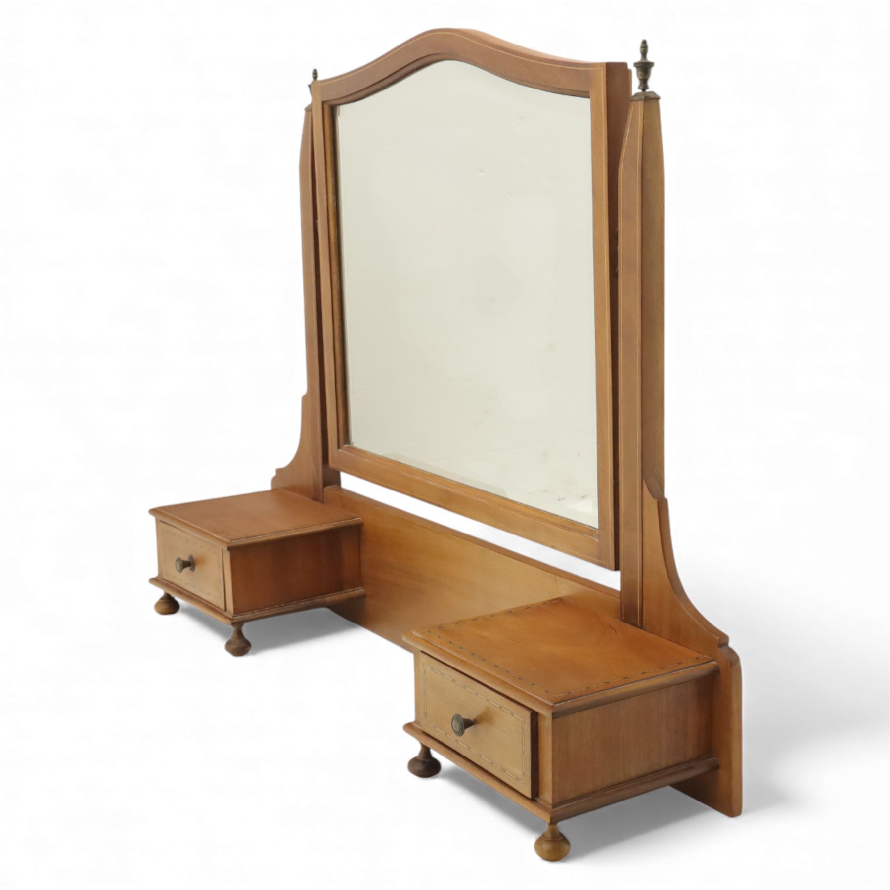 Two early 20th century mahogany swing dressing mirrors, comprising one with arched rectangular plate in a moulded frame on shaped supports, flanked by two inlaid trinket drawers (H 69cm, W 88cm, D 20cm), together with another rectangular plate mirror on turned supports upon bun feet (H 58cm, W 48cm, D 23cm)