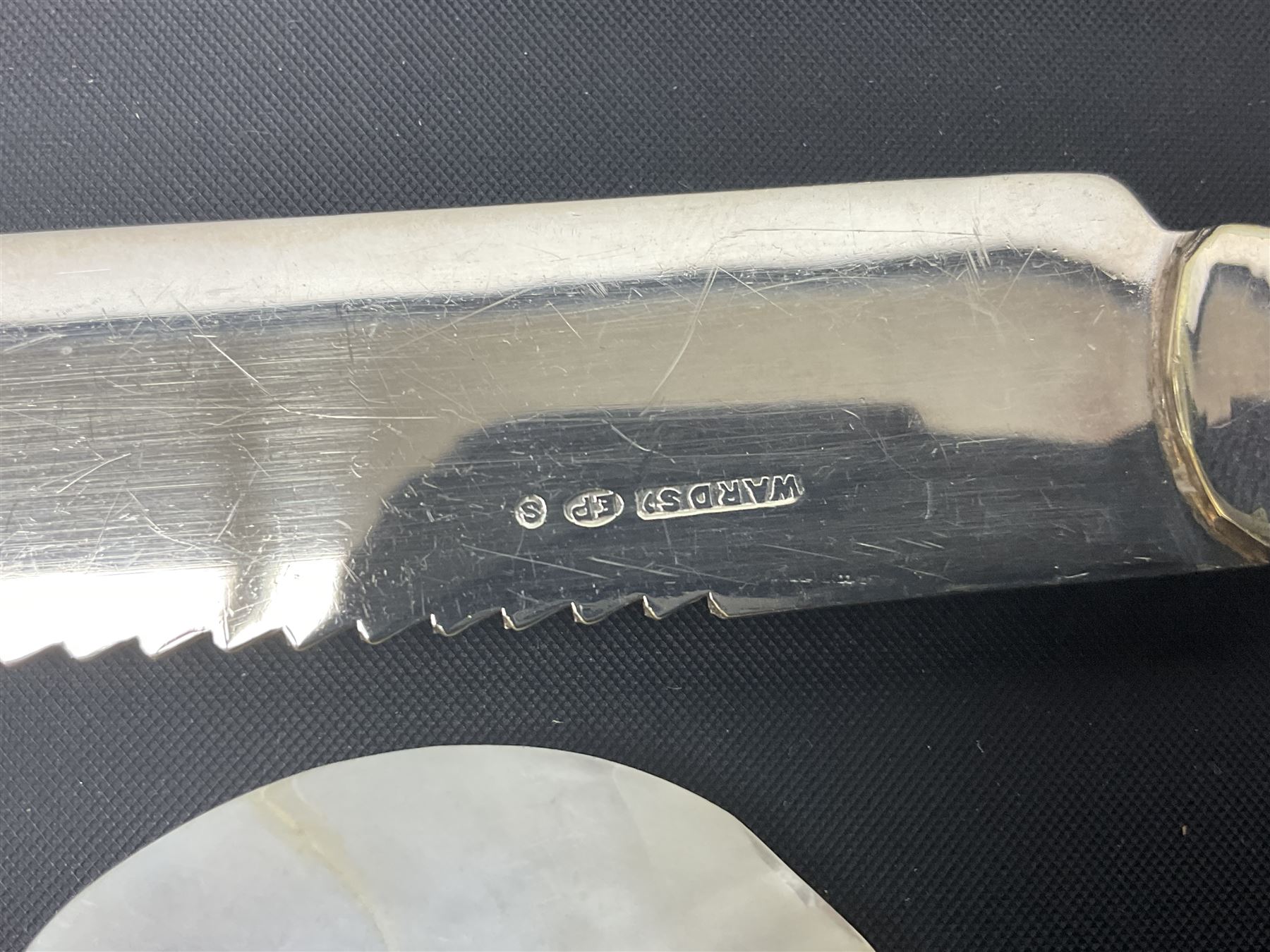 Mother of Pearl handled cutlery, with silver ferrules, comprising six fish knives and forks and six fruit knives and forks, the ferrules hallmarked Yates Brothers, Sheffield 1905, together with silver plated Edwardian three piece tea service and other flatware 