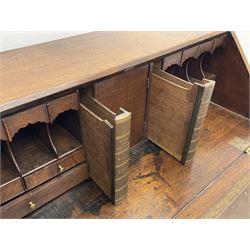 Georgian cross banded oak bureau, single fall front enclosing fitted interior with two sliding compartments disguised as leather bound books, four graduating drawers, bracket supports 