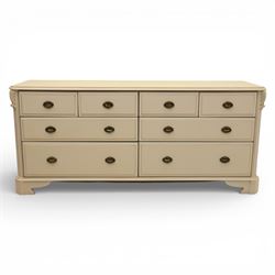 Contemporary French design white painted bedroom suite retailed by Barkers of Northallerton, comprising wide chest fitted with four short and four long drawers with oval brass handles (H 70cm, W 159cm, D 46cm), pair of bedside chests each fitted with three drawers (H 62cm, W 40cm, D 46cm), dressing table fitted with four short drawers and central kneehole with shaped apron (H 79cm, W 131cm, D 46cm) with matching framed wall mounted mirror (H 100cm, W 113cm), and full length standing mirror (H 175cm, W 73cm)