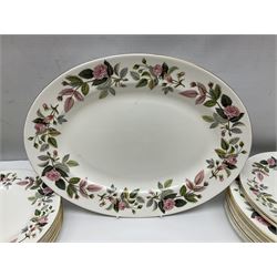 Wedgwood Hathaway Rose pattern tea and dinner wares, comprising twelve saucers, sixteen teacups, twenty tea plates, jug, sucrier, thirteen shallow bowls, sauce boat and saucer, two lidded tureens, larger jug, ten dinner plates, nine smaller plates and two large oval serving dishes