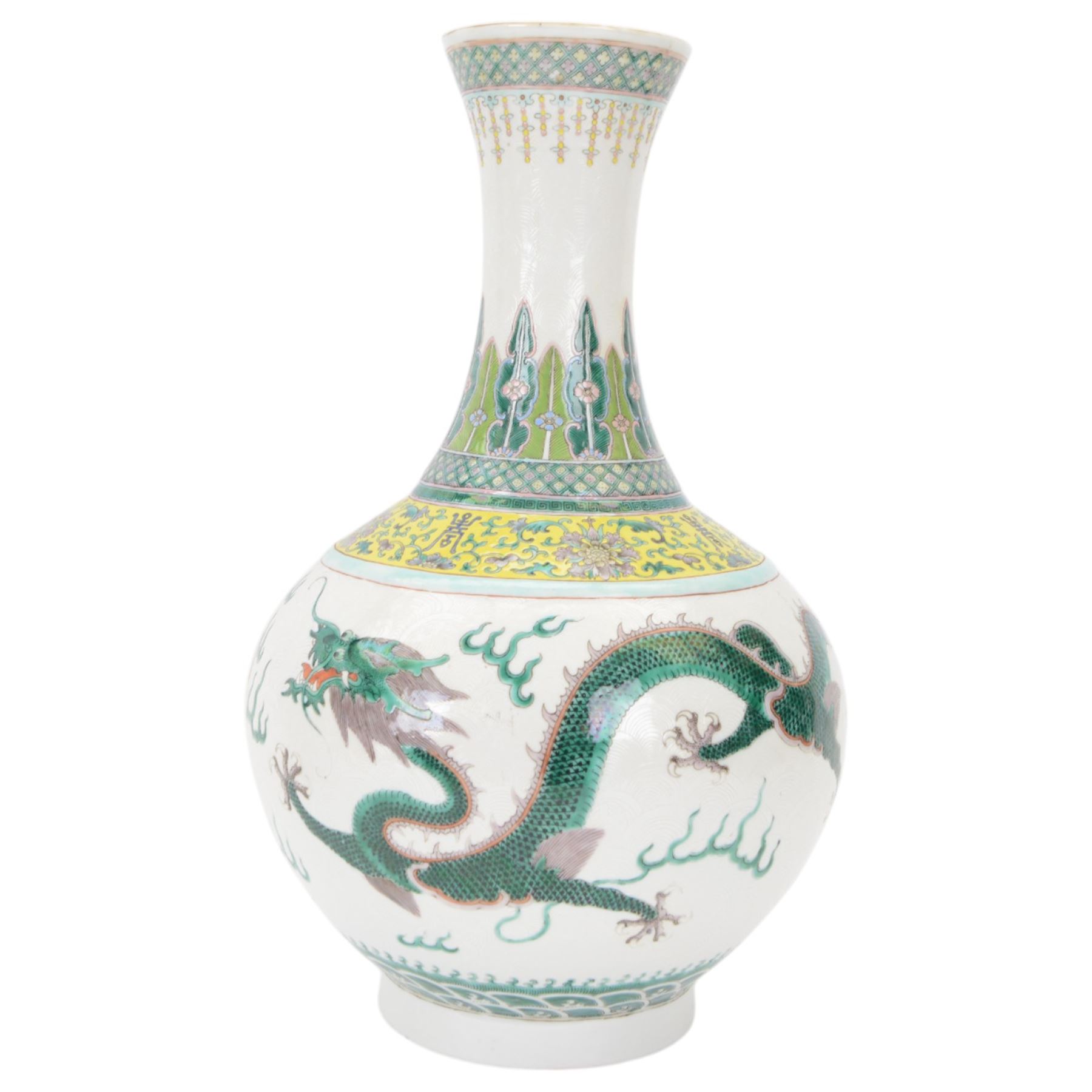 Pair 20th century Chinese famille verte bottle vases, each decorated with green and purple dragons chasing pearls amidst auspicious flames, the neck with yellow and green stylised foliate and cell borders, and the white glazed body incised throughout with fan shapes, each with red character mark beneath flanked by green dragons, H38cm

