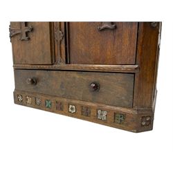 'Gnomeman' oak side cabinet, the hinged lid with gnome figure handle and carved cross straps enclosing divisions, panelled frieze over two doors with fist carved handles, drawer to base, adzed all over and panelled sides and back, the skirted base carved with a series of religious, floral and heraldic motifs

Provenance - This collection of early 'Gnomeman' furniture comes to us directly from the Whittaker family. The pieces were made by the vendor's father Thomas Whittaker in the 1930/40s for his own use. During this time, he lived in York and made items for himself and friends. Whittaker adopted the gnome as a signature and trademark after his move to Littlebeck, Whitby.