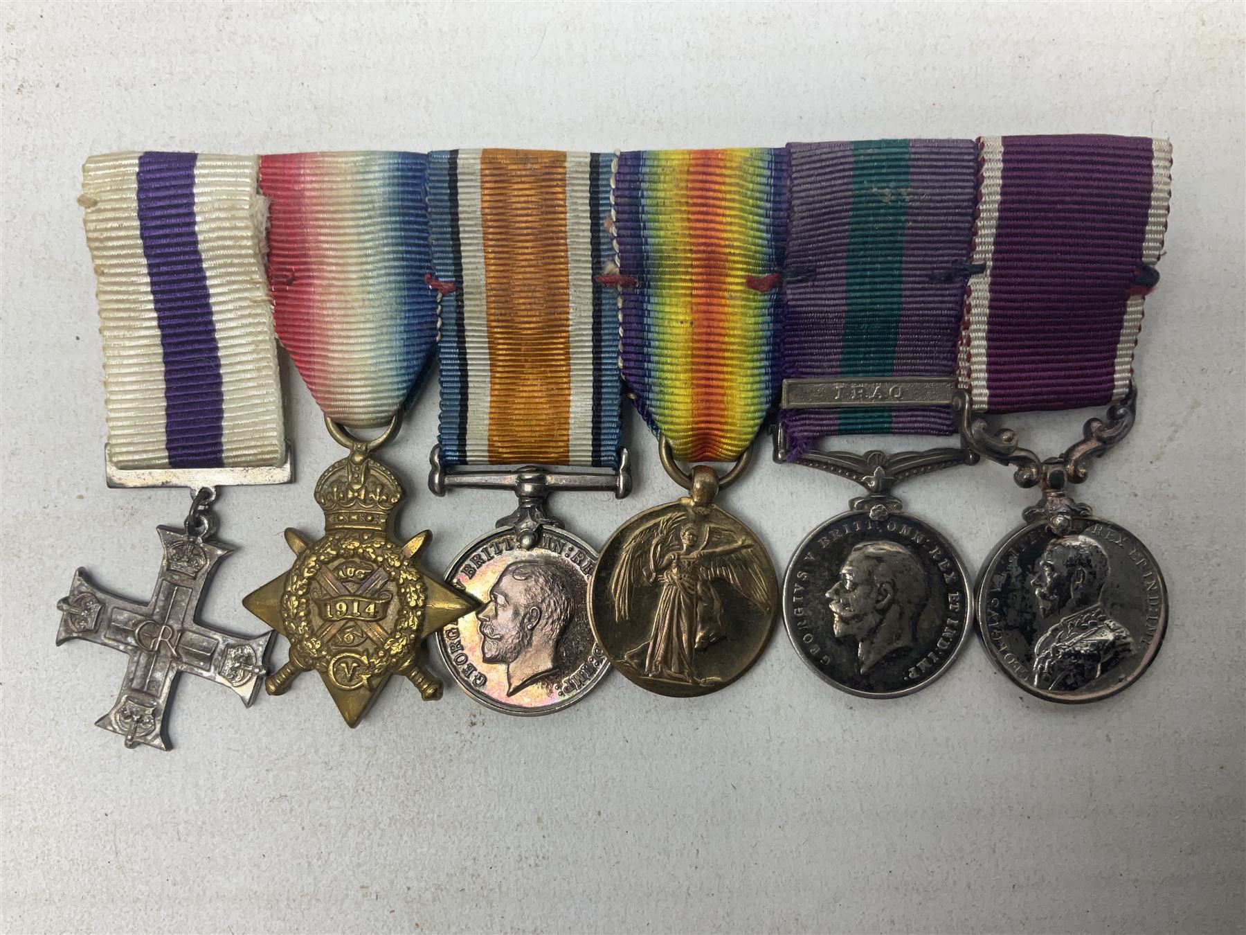 George V Military Cross miniature group of six medals comprising MC, WW1 trio including 1914 Star, Long Service and Good Conduct Medal and General Service Medal with Iraq clasp; and miniature group of four medals comprising Military OBE and WW1 trio including 1914-15 star; all with ribbons and both on pinned wearing bars