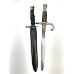 Swiss M1957 S.1.G. assault rifle bayonet, the 24cm double edged blade marked 'F over +W' for Waffenfabrik Bern and W343723, ribbed black grip and plastic scabbard L38cm; and cut down WW1 Turkish Mauser 1890/1903 pattern sword bayonet with numerous Ottoman Turkish Army marks, blade 26.5cm (Pommel has Ottoman Sultan's seal 'Tughra' - the same as on the Gallipoli Star awarded to Turks after the Gallipoli Campaign)