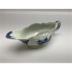 Large 18th century Lowestoft sauce boat, circa 1770, the body decorated with Hughes type floral moulding, and painted in underglaze blue with an Oriental landscape, and foliate sprigs, L23cm