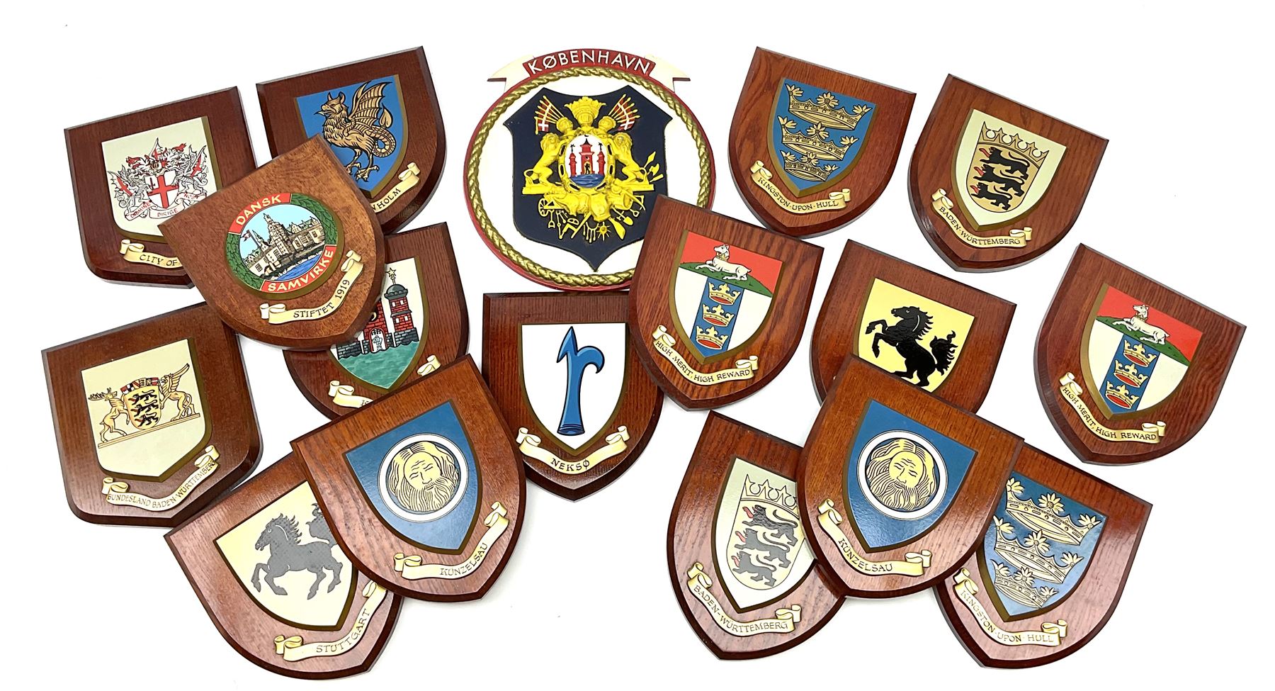 Various European cities and states, wooden heraldic shields each with hand painted raised shield including Baden Wurttemberg, Kunzelsau, City of London, Kingston upon hull etc, seventeen in total. . 
