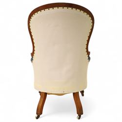Fine pair of mid-19th-century mahogany library armchairs, carved frame with balloon-shaped back with scrolled ends, rolled wide arms, ending in a scrolled volute above a serpentine seat rail, upholstered in mottled turquoise faux leather, button upholstered back, arms, and cushion seat, studded sides and apron, raised on scroll carved front feet and splayed rear legs on castors 