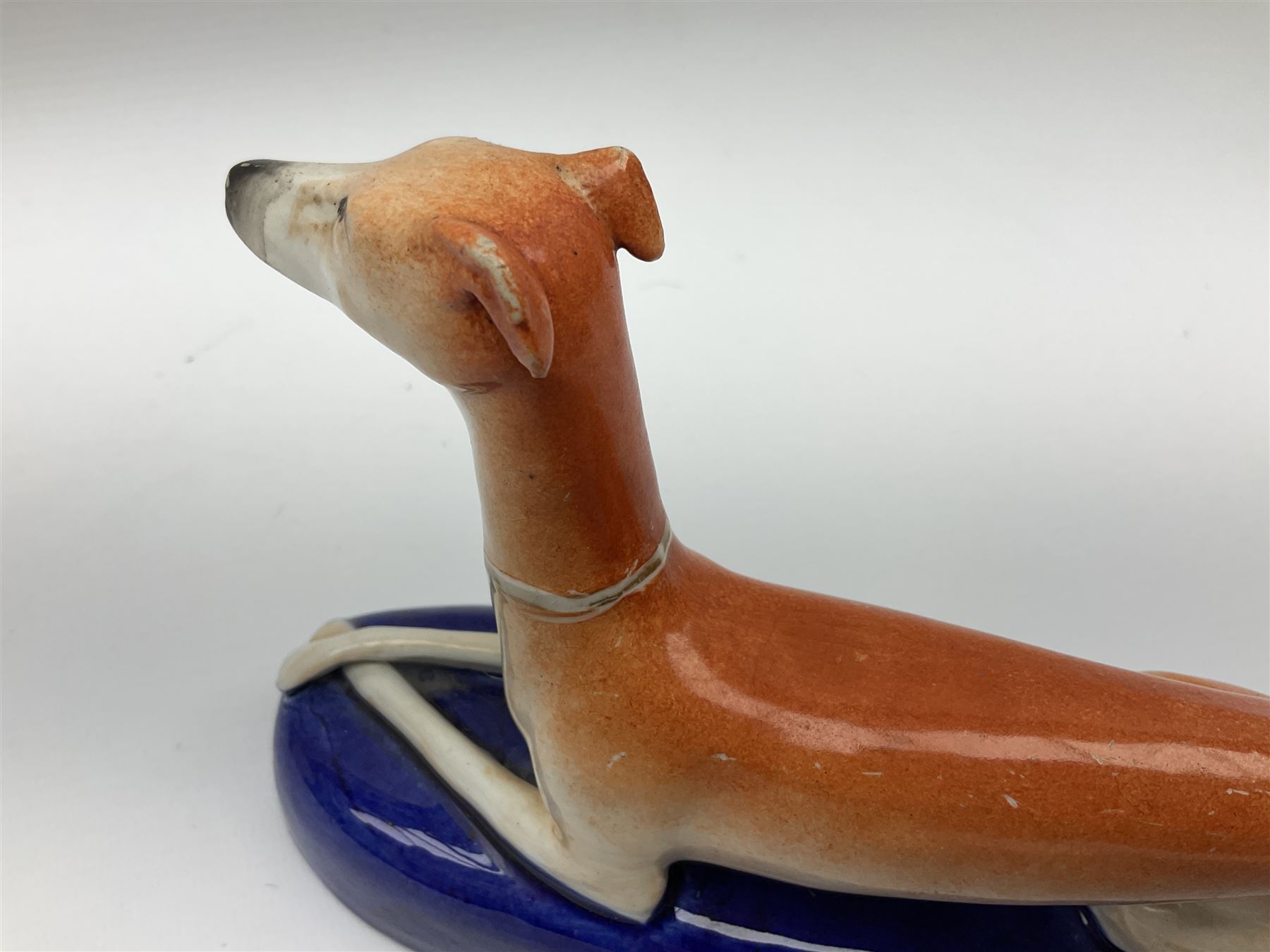 Pair of Staffordshire recumbent greyhound pen holders 
