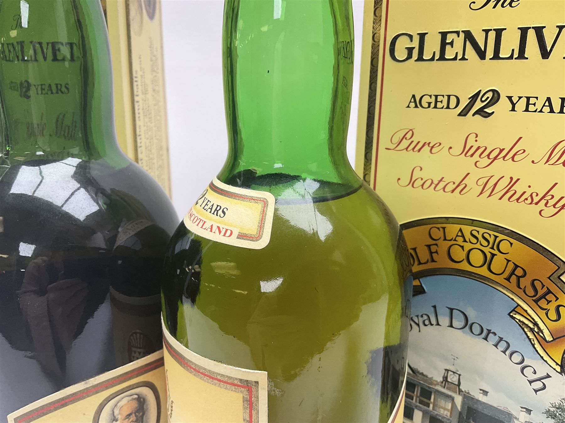 Two Glenlivet 12 year old, single malt Scotch whisky, 700ml 70% vol, each in original Classic Golf Clubs of Scotland presentation tin, Royal Troon and Royal Dornoch