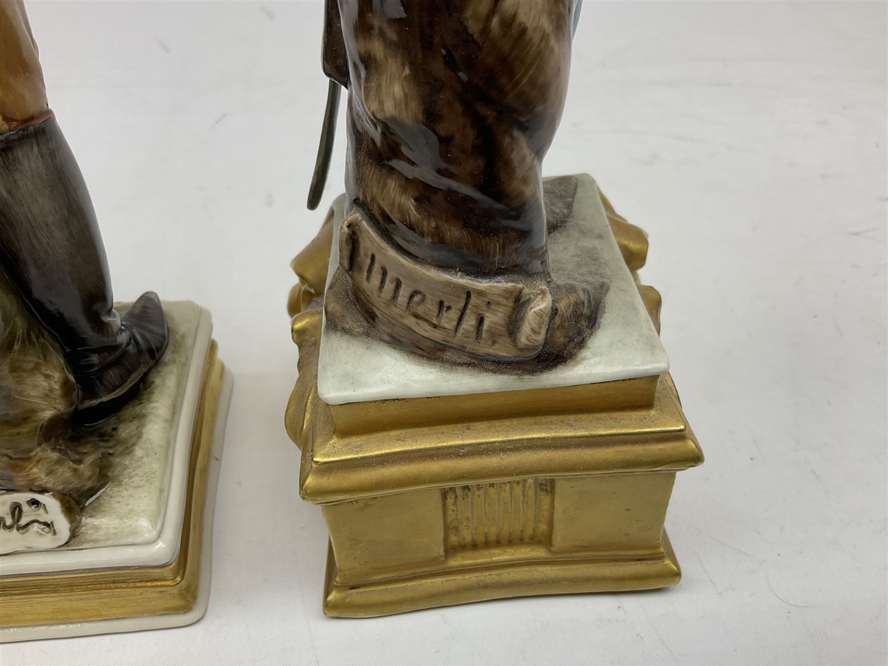 Group of seven Capodimonte figures of soldiers, to include four Bruno-Merli examples including Officer of the 12th Lancers 1820 and Captain of the 18th Hussars 1815, both raised upon ornate gilt plinths bearing British monarch motto in Latin 'Dieu et mon droit', and three further similar, all with crowned N mark beneath, tallest H32cm