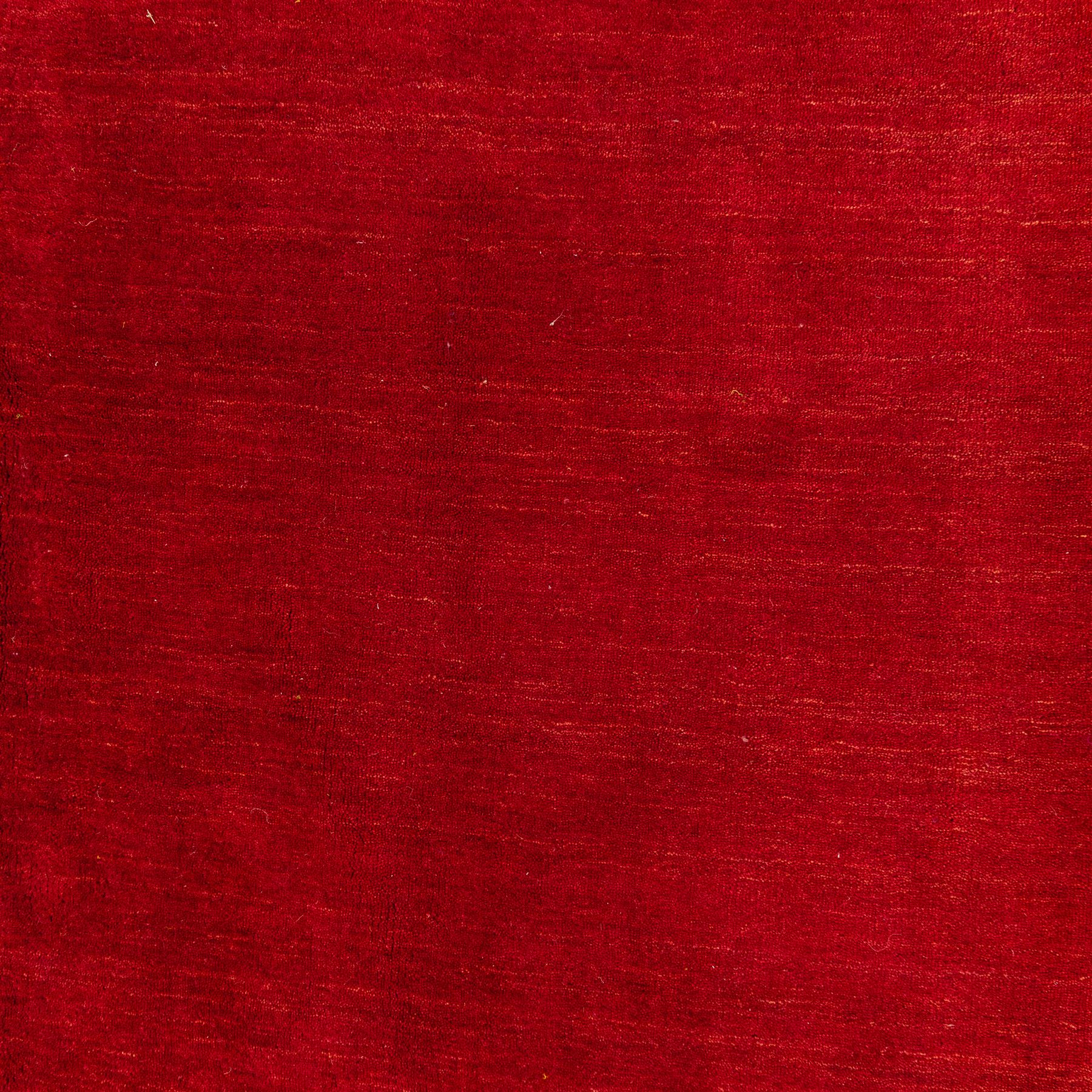 Indian hand-knotted wool Gebbeh design carpet, of rectangular form, woven in a rich madder red tone