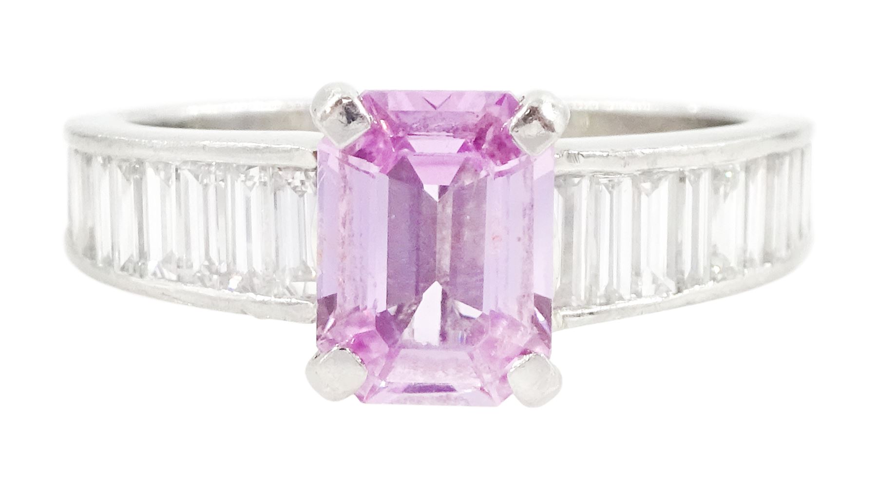 Platinum pink sapphire and diamond ring, single octagonal cut sapphire of approx 1.50 carat, each shoulder set with eleven, channel set baguette cut diamonds, London 2007, total diamond weight approx 1.05 carat