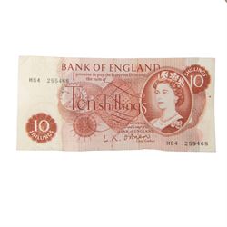 Three King George V pre-1920 silver florin coins, twenty three pre-1947 silver florins, one silver shilling, and a ten shilling note