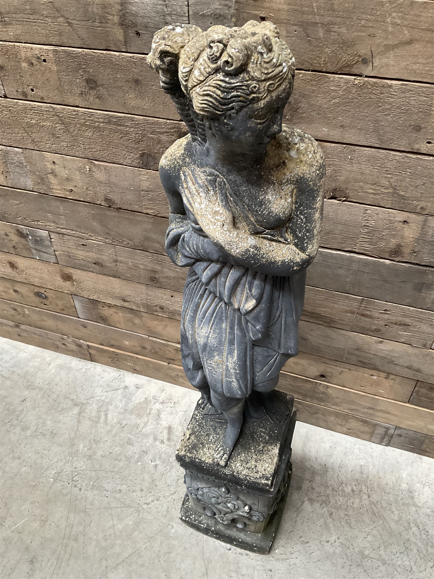 Cast stone weathered garden statue of Venus on pedestal