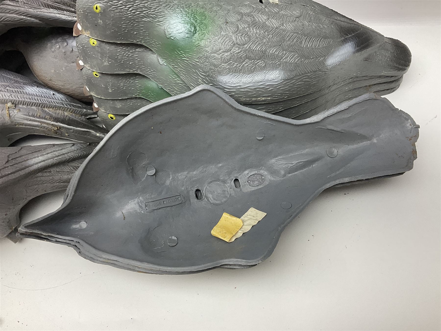 Eighteen plastic pigeon decoys comprising ten full body and eight shells with quantity of various stakes; some marked made in Italy