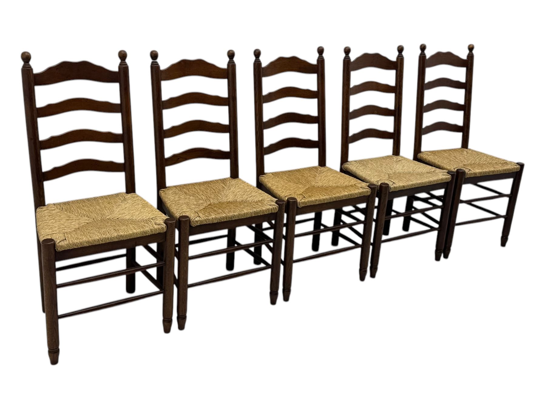 Set of ten 18th century design oak ladder back dining chairs, shaped cresting rail over four horizontal splats, rush seat raised on turned supports united by double stretchers
