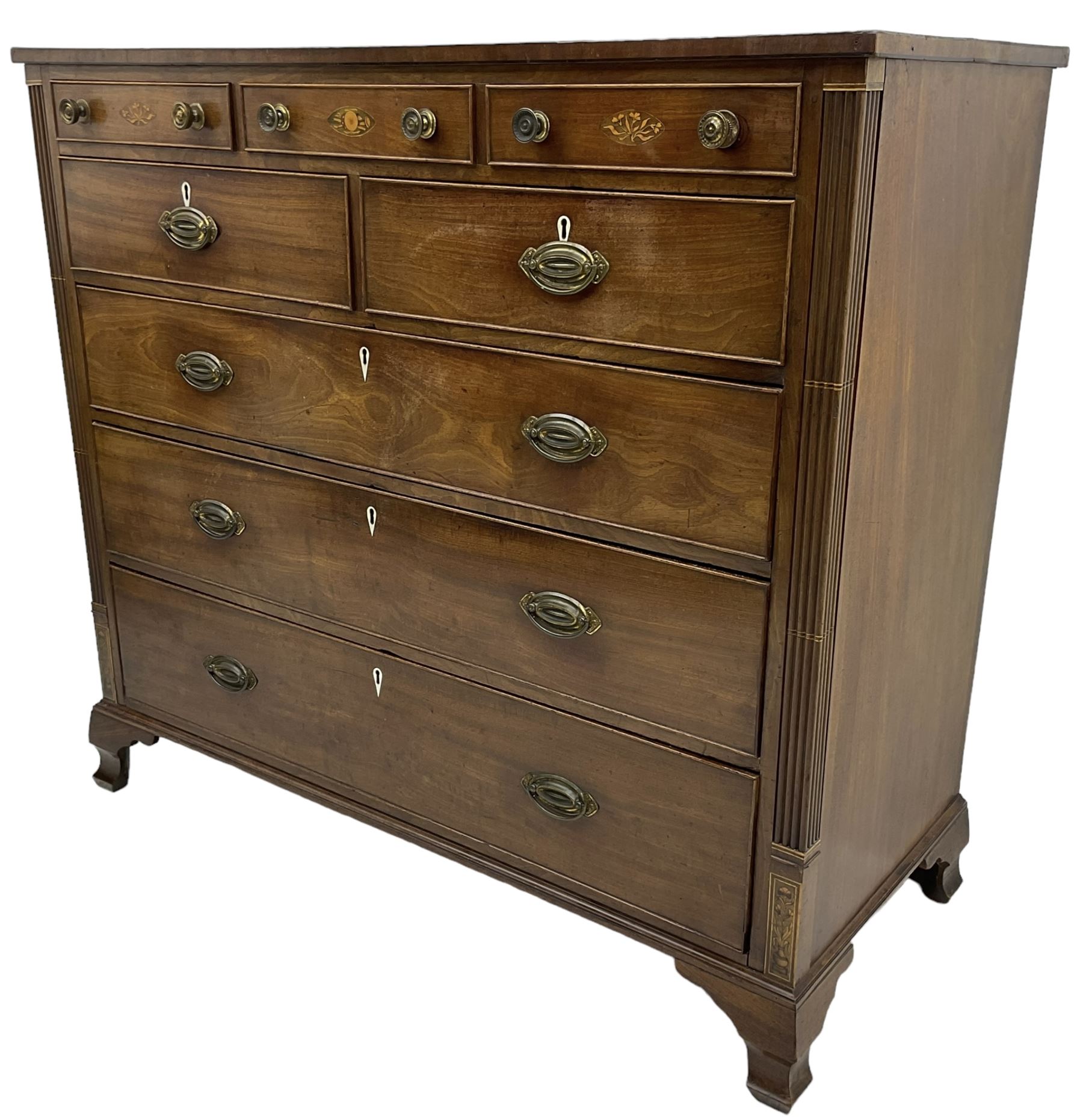 Early 19th century mahogany chest, three shallow frieze drawers over two short and three long cock-beaded drawers, canted corners with reeded moulded square columns, on ogee bracket feet