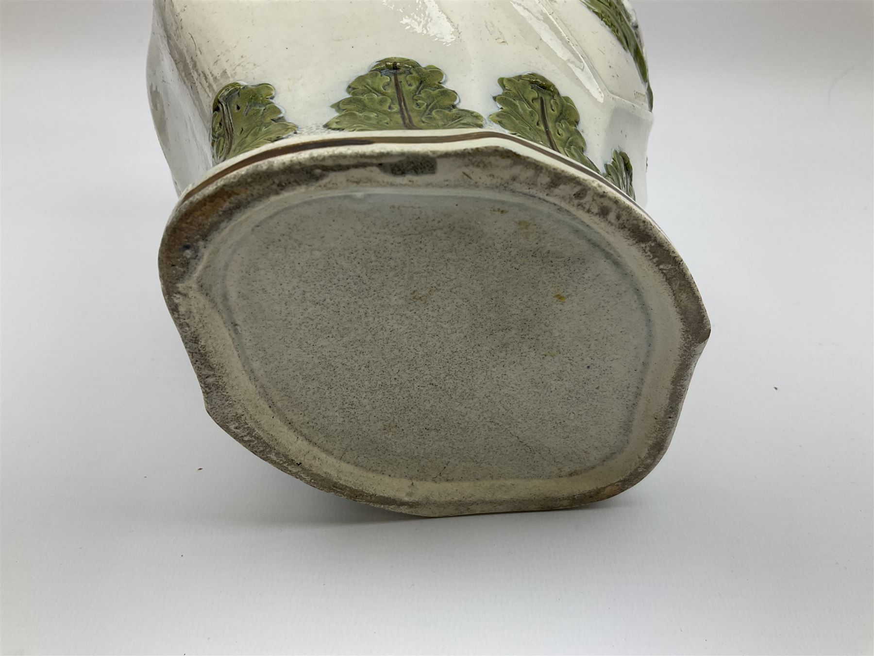 Early 19th century Prattware jug, circa 1800, decorated with two heart shaped panels of children, titled Sportive Innocence and Mischievous Sport, further decorated with acanthus and foliate borders, H22cm