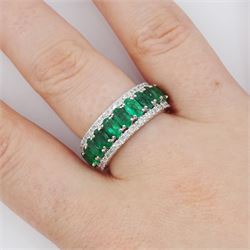 Platinum three row emerald and diamond half eternity ring, eleven oval cut emeralds with a row of round brilliant cut diamonds either side, hallmarked, total emerald weight approx 2.50 carat, total diamond weight approx 0.45 carat