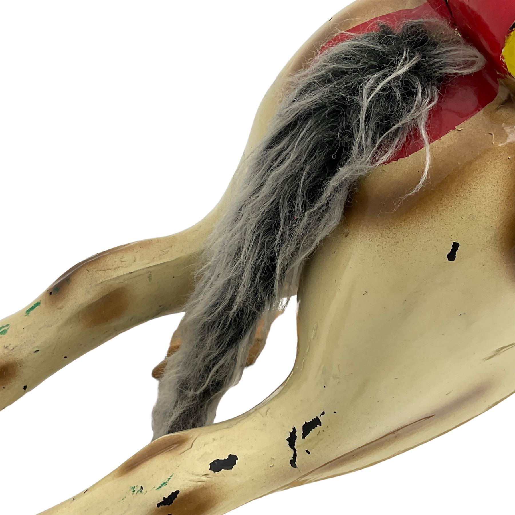 20th century rocking horse, painted body, glass eyes, metal stirrups and chain, wooden bow rocker