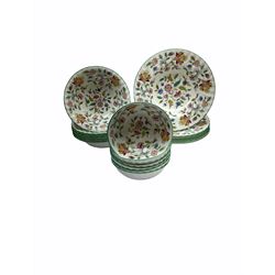 Minton Haddon Hall pattern tea and dinner wares, including basket dish, two covered tureens, six dinner plates, eight dessert plates, twelve tea plates, six soup bowls, six cereal bowls, teapot, coffee pot, milk jug, covered sucrier twelve tea cups and saucers, six mugs, footed bon bon dish, pair of candlestick holders, cake knife and slice etc (81)