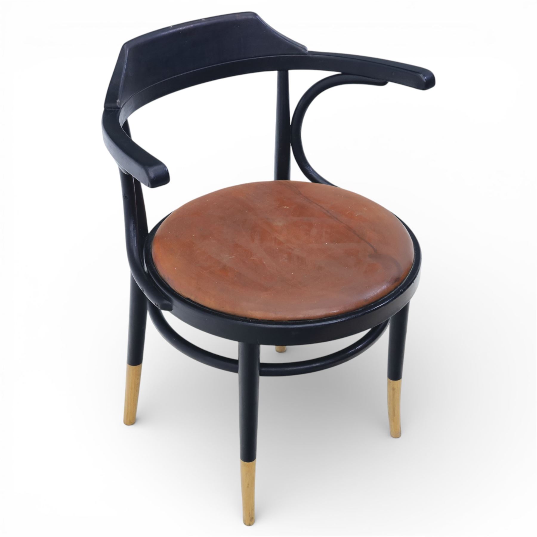 Thonet - 20th century ebonised elbow chair, bentwood construction with a circular brown leather seat, tapering legs with exposed wood supports
