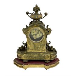 French - late 19th century 8-day clock set, gilt metal case with inset painted panels, leaf work and surmounted by an urn, case raised on a wooden padded base, with two associated Greek style urns mounted on a stepped alabaster plinth, painted dial with gilt numerals and hands, two train rack striking movement, striking the hours on a  bell. No pendulum or key.