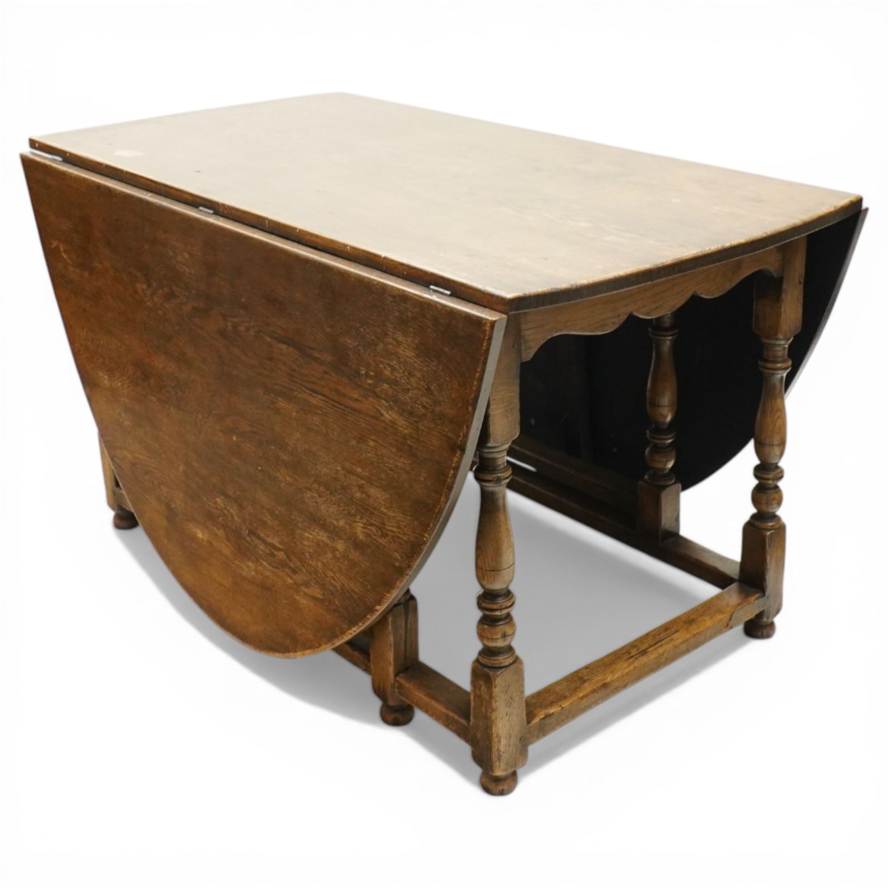 George III oak drop-leaf oval dining table with harlequin set of seven 18th century and later chairs including a comb-back Windsor, the table with turned gatelegs united by box stretcher, shaped apron extending to 212cm, the chairs of various forms, three Windsor carvers, a comb-back Windsor, plus a set of three Georgian mahogany dining chairs, pierced splat backs, with matching drop-in upholstered seats