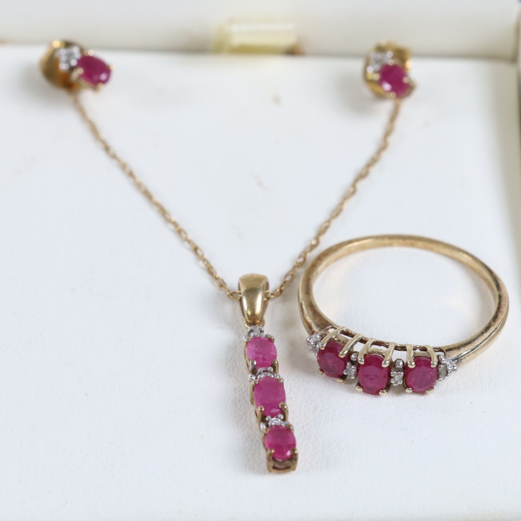 Silver-gilt stone set suite of jewellery, including ring, necklace and pair of earrings, together with five stone set/enamel rings and a coin ring