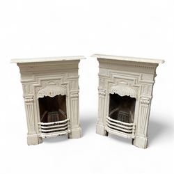 Two Victorian small cast iron fireplaces in a white finish