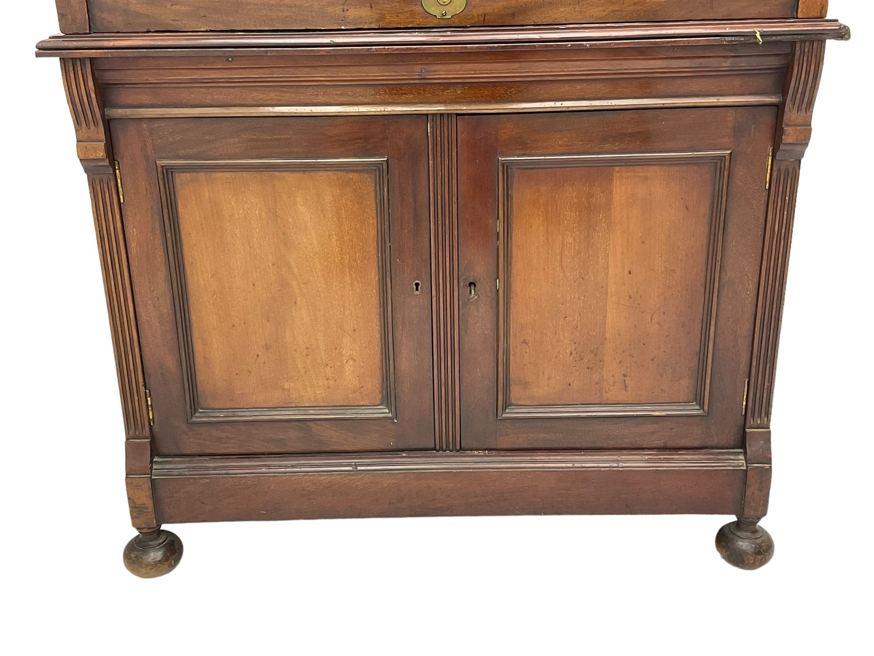 The Shannon Limited - late Victorian walnut filing cabinet, fitted with twenty-four small filing drawers, each with brass handle with label holder, fluted uprights, double cupboard below enclosed by two panelled doors, on turned feet, with brass plaque inscribed 'The Shannon, Limited, Ropemaker St. London, E.C.'