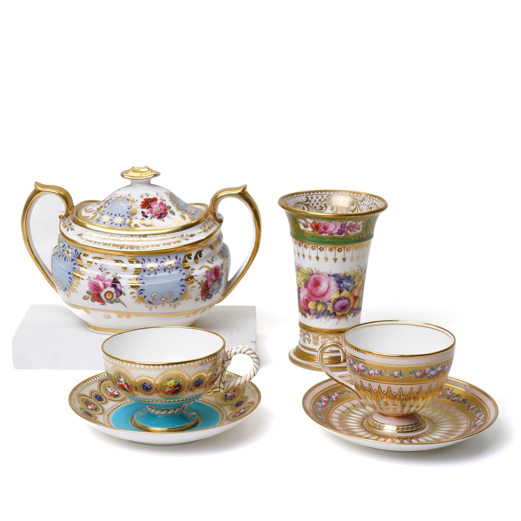 Brown-Westhead, Moore & Co cabinet cup and saucer, with rope twist moulded handle, hand-painted with floral reserves against a white and sky blue ground, heightened profusely with gilt, together with a pink hand-painted example, and a 19th century spill vase and twin-handled covered sucrier (4)