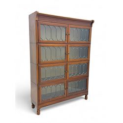 Early 20th century Globe Wernicke design stacking walnut bookcase, fitted with four sections each with two leaded glass doors, raised on turned feet