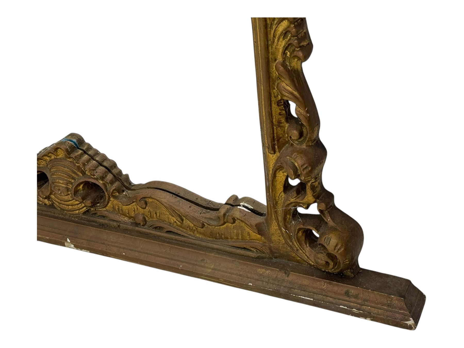 Victorian design gilt framed overmantel mirror, the arched and moulded frame adorned with scrolling foliate motifs and acanthus leaves, surmounted by a pierced cartouche, plain mirror plate, resting on a shaped base