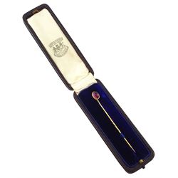 Two early 20th century gold stick pins, including a seed pearl set ribbon bow and cabochon garnet, one boxed