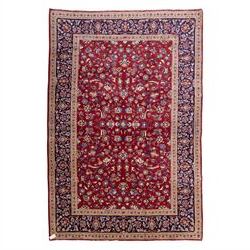 Central Persian Kashan hand-knotted rug, crimson field, decorated with an all-over floral ...