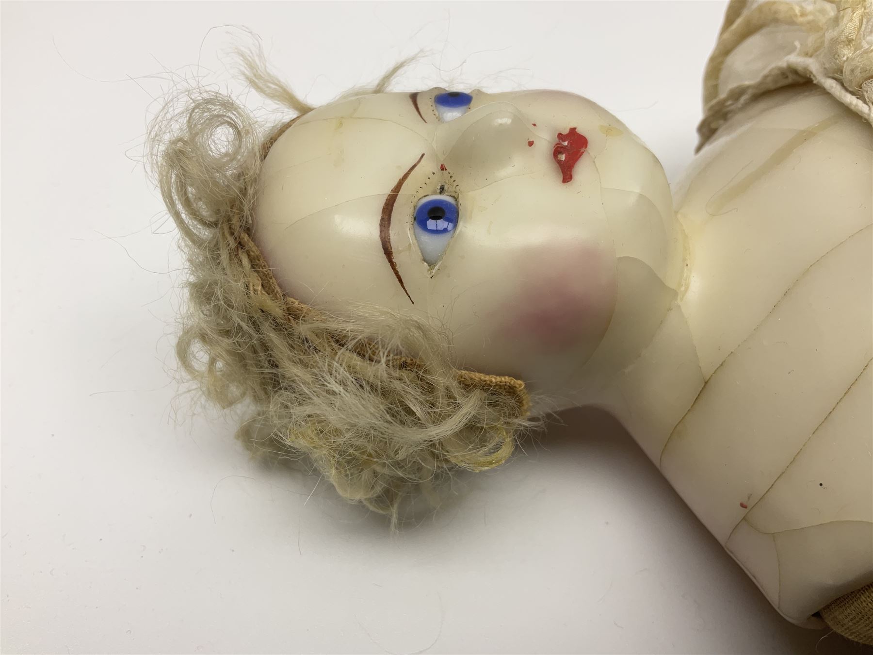 Victorian wax shoulder head doll with pale complexion, applied hair, inset glass eyes and fabric covered jointed body with kid leather lower arms; white linen dress and undergarments H50cm
