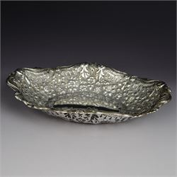 Late Victorian silver dish, of oval form, profusely embossed with flowers with a scrolling...
