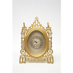  Mid 19th century Gothic style pierced brass strut clock in the manner of Thomas Cole, retailed by 'Howell, James & Co. London', engine turned silvered dial with Roman numerals, subsidiary seconds dial, eight day movement with balance escapement, the back inscribed 'Howell, James & Co. to the Queen, London, Paris', in presentation case, with encased cylindrical winding key, H15cm  