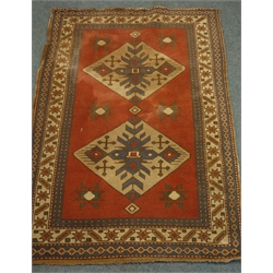  Turkish red ground rug, two equal set medallions with repeating star border, 126cm x 180cm  