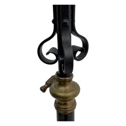 Late 19th century wrought iron and brass pulpit lamp, featuring an adjustable stem with a spiral twist detail, brass foliate mounts, and a tripod base with scrolled feet and decorative floral accents