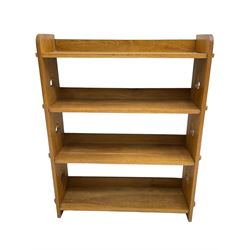 Mid-20th century light oak open bookcase, fitted with four pegged shelves, shaped end supports pierced with clubs