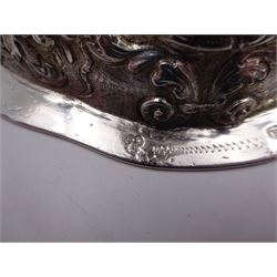 German silver chalice, the bowl, stem and foot each with 19th century repousse and chased decoration depicting putti masks, C scrolls and flowers, set with two hand painted porcelain roundels, possibly Berlin, and six later applied enamel roundels, each depicting religious scenes, the gilded bowl upon knopped stem and spreading octofoil foot, the base with marks for Munich, c.1695 and maker's mark FK