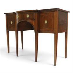 Regency period inlaid mahogany bow-breakfront sideboard, shaped rectangular top with crossbanding and ebony stringing, central convex frieze drawer flanked by cupboard and cellarette drawer, over fan-inlaid spandrels, raised on square tapering supports
